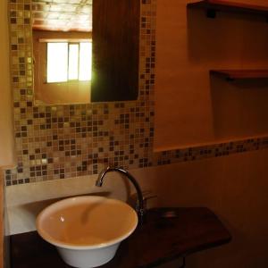 a bathroom with a sink and a mirror at TrinidadTraslasierra in Las Rabonas
