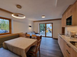 a kitchen and a dining room with a table and a tableablish at Residence Armonia in Colfosco