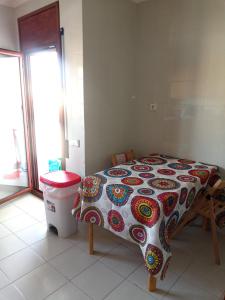 a bedroom with a bed with a table and a trash can at Ebro Escape Luxury Apartment in Móra d'Ebre