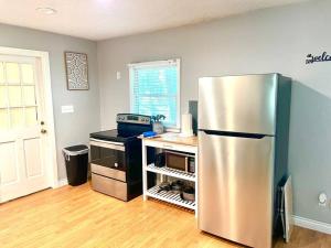 a kitchen with a stainless steel refrigerator in a room at Town & Country Hideaway - 1BR/1BA, 20 min FAMU/FSU in Tallahassee