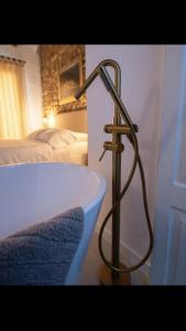 a bath tub with a metal stand next to a bed at MEDITERRÀNIA RURAL in Cabanes