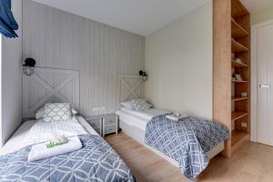En eller flere senge i et værelse på Wave Apartments - SILVER NADMORZE