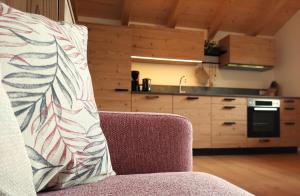 a pillow sitting on a couch in a kitchen at Riedlhof in Sillian