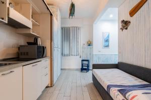 a small kitchen with a bed in a room at IM INTERNATIONAL 1 - Galleria Raggio 3/9 in Rapallo