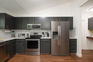 a kitchen with gray cabinets and stainless steel appliances at Newly Reno'd High Springs Haven in High Springs