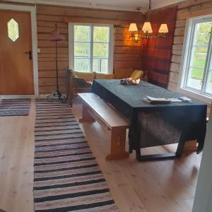 ein Esszimmer mit einem Tisch und einer Bank in der Unterkunft Brekkveien 81-meget sentral hytte,15 min å gå til Røros sentrum in Røros