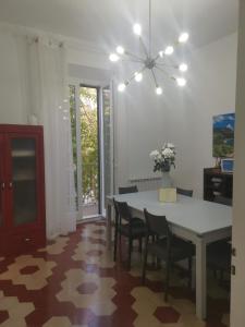 a dining room with a white table and chairs at CASA PAVONI in Falconara Marittima