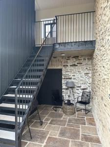 a staircase in a room with two chairs and a desk at The Hayloft in Strabane