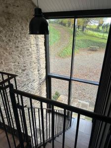 a window with a view of a stone wall at The Hayloft in Strabane