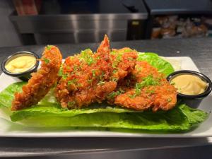 a plate of food with fried shrimp on lettuce at Devoncove Hotel Glasgow City in Glasgow