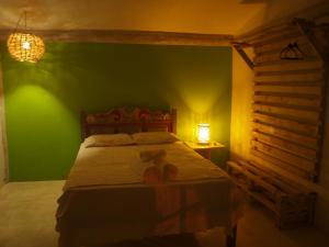 Tempat tidur dalam kamar di Pousada Casa da Praia Itaúnas