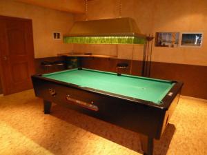 a pool table in the middle of a room at Pension Edelweiss in Sankt Martin am Tennengebirge