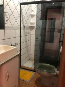 a bathroom with a green toilet and a shower at Golden Residence in Florianópolis