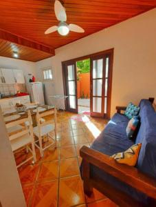 a living room with a blue couch and a table at Golden Residence in Florianópolis