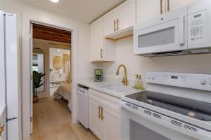 a kitchen with white cabinets and a sink at Hope Home in Clermont