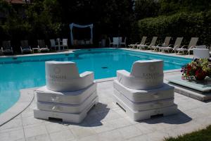 a white toilet sitting on top of a white tub at iH Hotels Logos Forte Dei Marmi in Forte dei Marmi