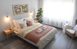 a bedroom with a bed with two towels on it at Pannonian sailor in Novi Sad