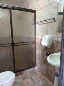 ein Bad mit einer Dusche, einem WC und einem Waschbecken in der Unterkunft COLIBRÍ TINY HOUSES in Fortuna