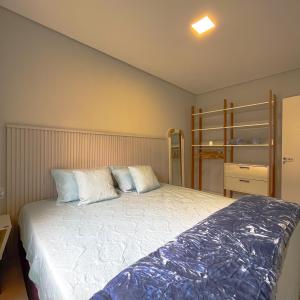 a bedroom with a large bed with two pillows at Apto Adilson in Foz do Iguaçu