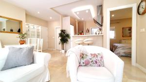 - un salon avec deux canapés blancs et une chambre dans l'établissement Apartamento EL PATIO, à Fuengirola