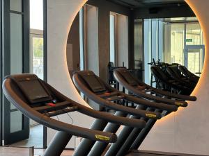 a row of chairs in a gym with a large mirror at Prince Palace Hadera Beach in H̱adera