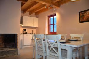 a kitchen and dining room with a table and chairs at LES CHALETS D'AURE. in Aragnouet