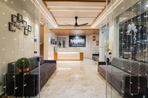 a living room with couches and a television at HOTEL AYODHYA in Virpur