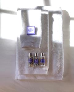 three bottles of soap sitting on a towel at Element in Viseu