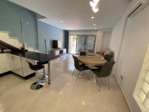 a kitchen and dining room with a table and chairs at Villa Murcia Paradise in Los Alcázares