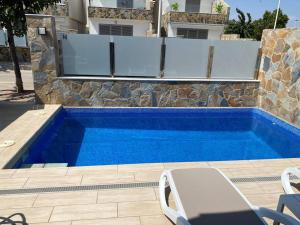 a swimming pool in front of a house at Villa Murcia Paradise in Los Alcázares