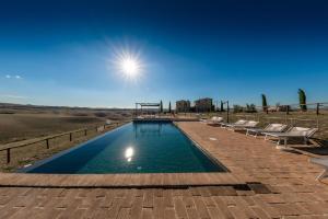 a lap pool with chairs and a playground at Casa Lavanda - Podere Fossaccio in Asciano
