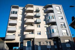 a tall building with balconies on the side of it at City Osijek, CENTAR, SELF CHECK IN, free private parking in Osijek