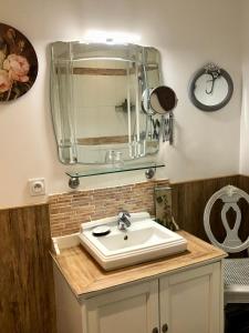 a bathroom with a sink and a mirror at Reglisse et Pain d'Epices - Chambres d'hôtes in Honfleur +74 photos