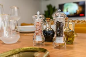 a wooden table with two glass containers filled with food at Safari Family Villas near Park Aventura,Lake,Zoo in Braşov