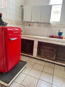 a red refrigerator is sitting in a kitchen at Casa Grande Hospedagem in Brumadinho