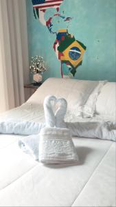 a towel in the shape of a heart on a bed at Vale Aventura in Colinas