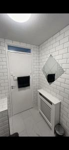 a white bathroom with a white door and a heater at Entire 3 bedrooom holiday home in Liverpool