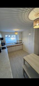a room with a kitchen with a table and a counter at Entire 3 bedrooom holiday home in Liverpool