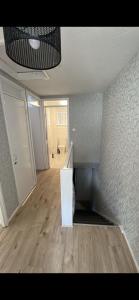 an empty room with a kitchen and a hallway at Entire 3 bedrooom holiday home in Liverpool