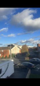 a view of a parking lot with cars parked in front of a building at Entire 3 bedrooom holiday home in Liverpool