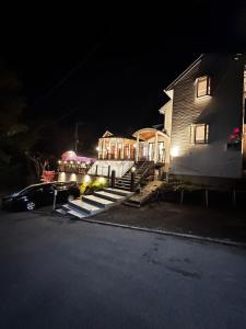 a house with a car parked in front of it at night at FUJIYUKI in Yamanakako