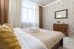 - une chambre avec un lit, une commode et une fenêtre dans l'établissement Квартира в ЖК Promenade Expo Block D, à Astana
