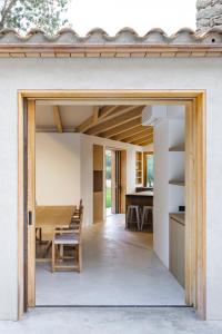 a kitchen and dining area of a house with a sliding glass door at Molí Del Senyor in Casavells