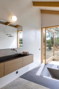 a kitchen with a sink and a large window at Molí Del Senyor in Casavells