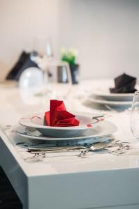 une rose rouge sur une plaque sur une table dans l'établissement M Inn - Seaview with sunny terrace, à Kastav