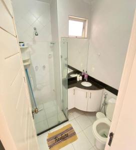 a bathroom with a shower and a toilet and a sink at Apto 2quartos Buzios/Vista p/mar/Piscina in Nísia Floresta