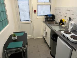 a small kitchen with a counter and a sink at OAKhouse studio 76 in Kent