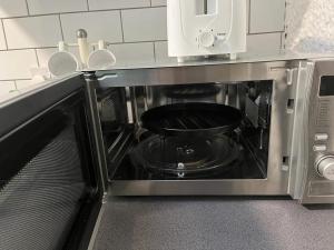 a black pot is inside of a microwave at OAKhouse studio 76 in Kent