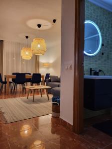 a living room with a table and a dining room at King`s Apartaments in San Javier
