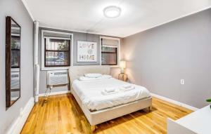a bedroom with a bed and two windows at Superb 1BR Apartment in NYC! in New York